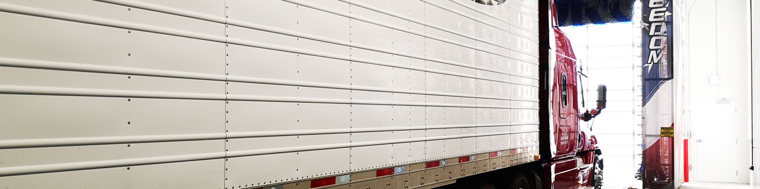 Semi truck getting washed in an automatice wash system
