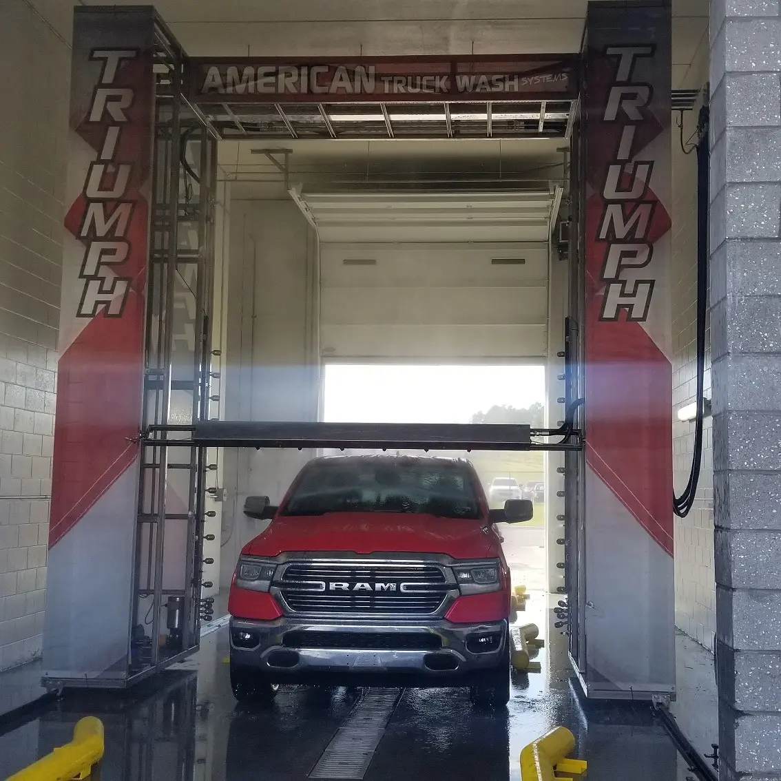 Pickup truck in a touchless gantry truck wash system